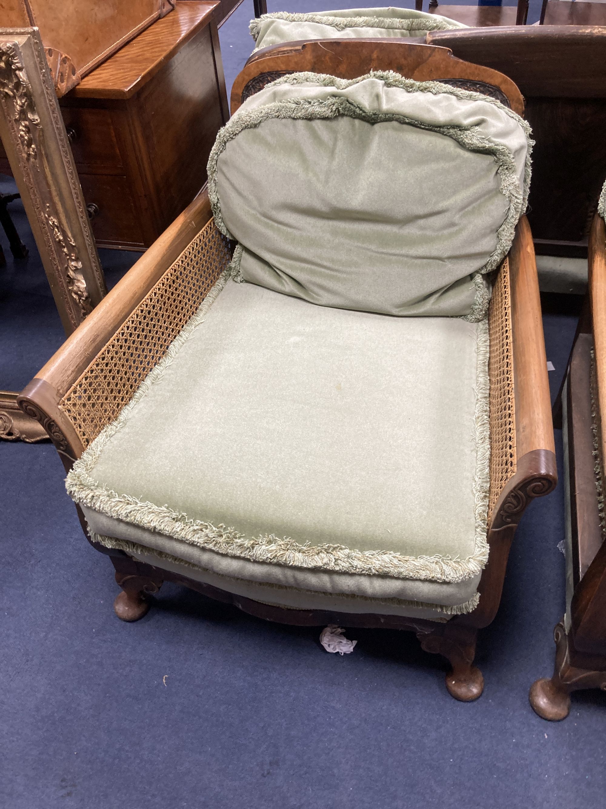 A 1920s mahogany framed three piece Bergere suite, together with a stool